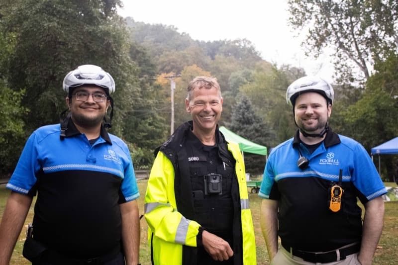 Community partners and police officer smiling at the Fox Chapel 5K